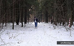 Barefoot Claudia is captured in the cold winter forest