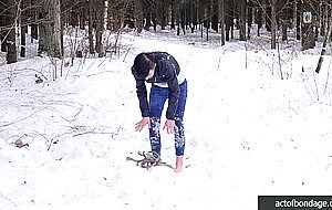 Barefoot Claudia is captured in the cold winter forest