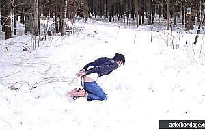Barefoot Claudia is captured in the cold winter forest