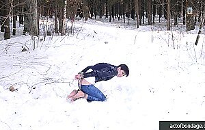Barefoot Claudia is captured in the cold winter forest