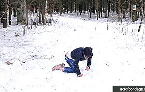 Barefoot Claudia is captured in the cold winter forest