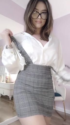 Blonde woman in plaid skirt and glasses