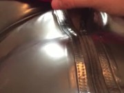 Man In Latex Catsuit Rubbing Cock With Satin Sheets