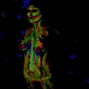 Glowing paint at night on a naked body.