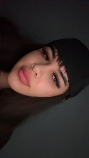 Close-up of a woman with dark hair and a black headband