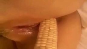 Nice closeup of a wild bitch petting her bald cunt with a corn