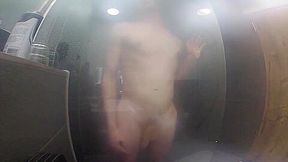 Twink jerks off and presses cock against glass in steamy shower session