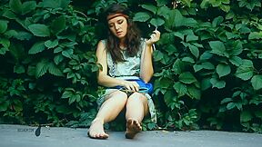 Adorable Brunette Hippy Gal Sits In Shrubs And Her Dirty Feet While Smoking