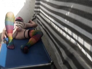 Caged sissy plays with her sex tool on public balcony