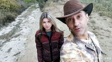 Gina Gerson and a brunette share intimate moments with a tattooed man in the autumn woods