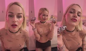 Blonde tease shows off her collection of metal chastity cages