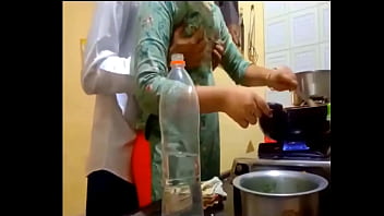 indian new married couple romance in kitchen.