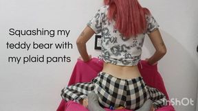 Squashing my teddy bear with my plaid pants