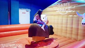 Hot Brunette with Big Tits Saddled Bull in Amusement Park