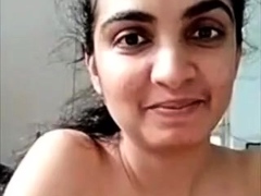 Horny busty indian milf strips nude to show round tits