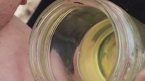 Pee fetish with girl pissing into jars