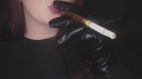 Smoking using a cigarette holder and wearing leather gloves