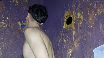Young twink guy sucks a hard male dick at glory hole while public cruising