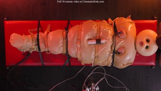 Zoey Ziptie in inflatable latex sack