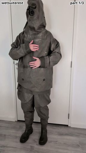 Putting on Zodiac Zodiak heavy rubber hazmat suit over plastic pants and gas mask
