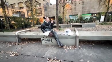 Stiletto-clad dominatrix smokes outdoors in leather boots that hey slicken thigh by thigh