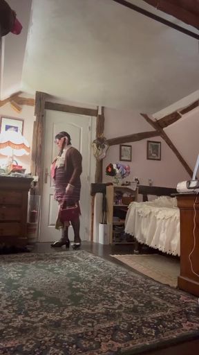 Dressed in a small plaid skirt with suspenders for an evening