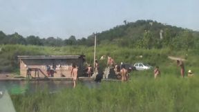 Chinese Men swimming at lake