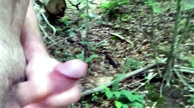 Solo male masturbation in the forest ends with cumshot by the river