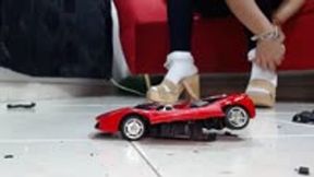 crushing hard the rastar Ferrari 458 Italia in wooden heel sandals and socks in jeans