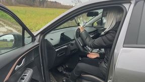 A girl in leather boots drove a car, but eventually got stuck in the mud, she doesn't know how to push her car out of this mud, but she desperately tries (short version)