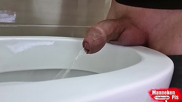 Uncut dick pissing in the toilet