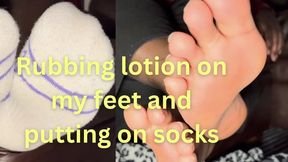 Rubbing lotion on my feet and putting on socks