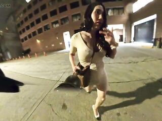 Kelly goes for a walk downtown in a constricted lascivious suit