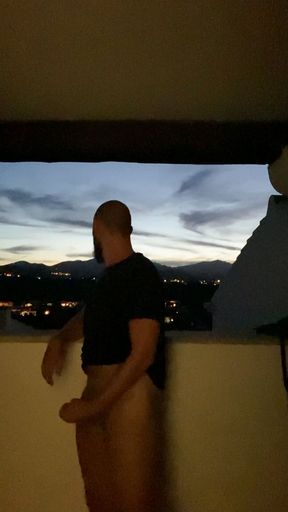 Jerking off on the balcony and shooting a hot load