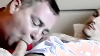 Chubby mature man sucks two cocks in interracial threesome