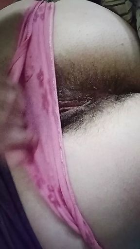 Tease in pink panties, hairy pussy lips.