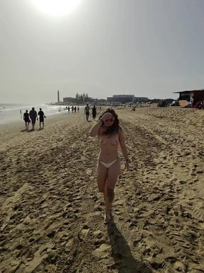 Topless babe struts her stuff at the beach