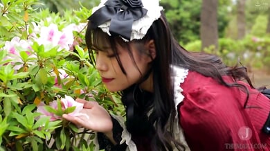 Young Japanese woman in red dress shares intimate kiss with older man