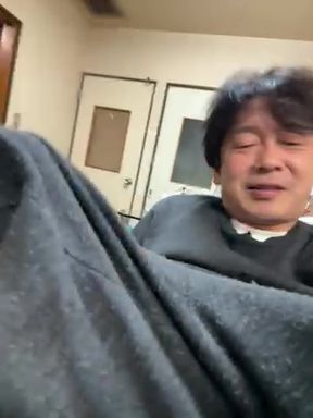 Elderly Japanese man rubbing his erect penis