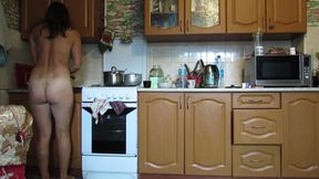 Naked hostess in the kitchen