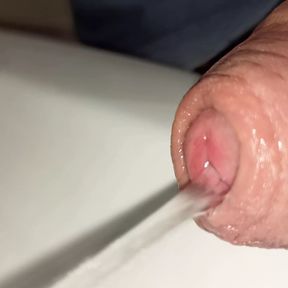 close-up of uncut pissing cock