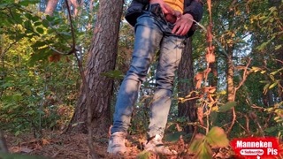 Guy long pissing in the forest under a tree
