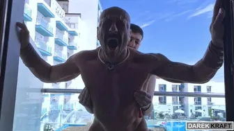 Daddy fucks a twink bareback on the balcony in public view