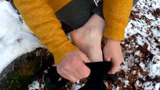 Slapping her naked pussy in the snow