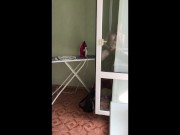 guy jerks off his big dick by the window
