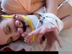 Amateur girl gets another girl's feet tied up to her face