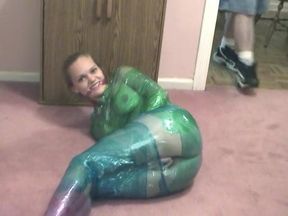 Fetish chick loves being wrapped in green plastic with her shaved pussy