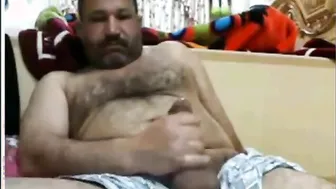 Mature Arab bear strokes his hairy cock until he cums