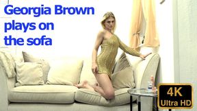 Georgia Brown plays on the sofa