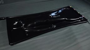 Orgasms in a black latex bed with a pear gag